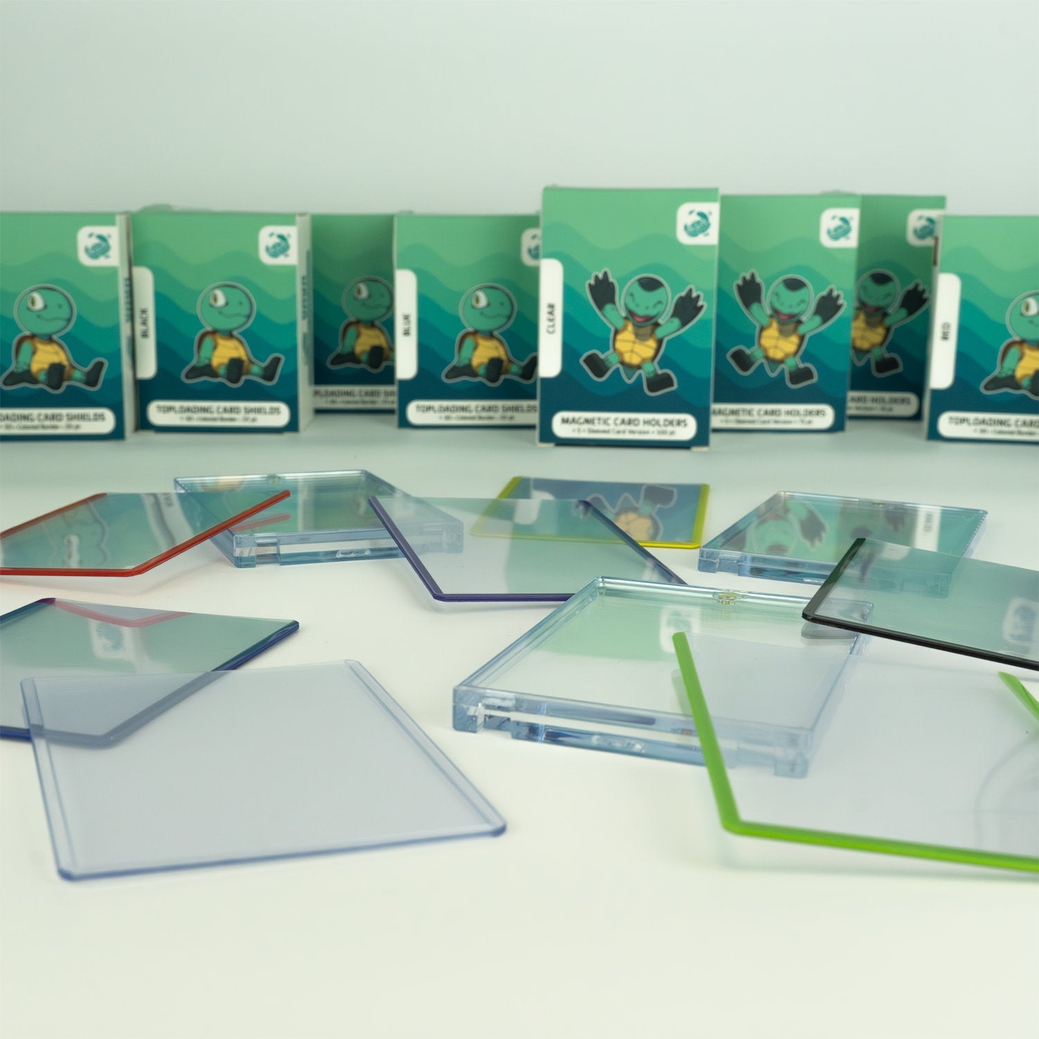 Payashell TCG accessories featuring colored toploaders and magnetic card holders—essential add-ons for ultimate trading card protection.