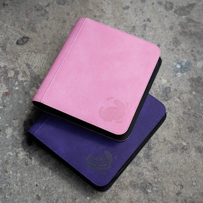 stacked pastel pink and purple caratex card shield zip-up album binder for standard and japanese size tcg trading cards in toploader card shields with 8 sideloading pockets and 20 double-sided black pages 