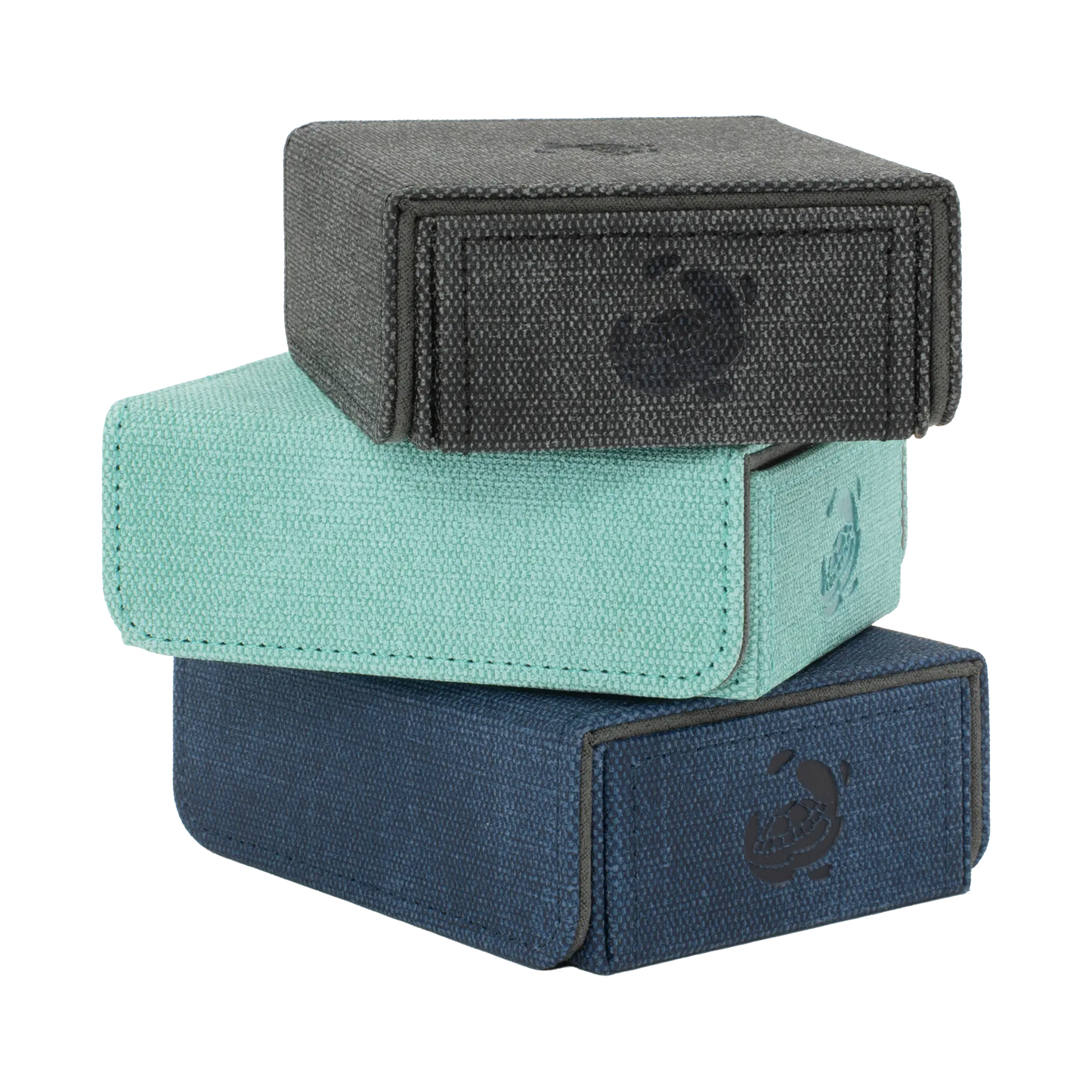 stack of black, turquoise and night blue resistant denim-like caratex tokencove boxes with removable, magnetic cover for dice, tokens and counters or sleeves tcg trading cards