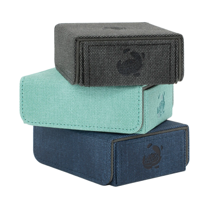 stack of black, turquoise and night blue resistant denim-like caratex tokencove boxes with removable, magnetic cover for dice, tokens and counters or sleeves tcg trading cards