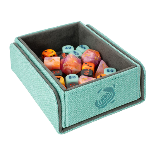 open turquoise resistant denim-like caratex tokencove box for dice, tokens and counters or sleeved tcg trading cards filled with various dice and with removable, magnetic cover clipped to bottom