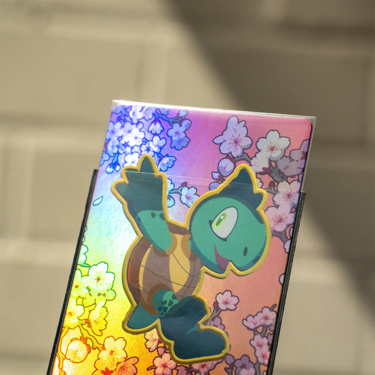 card sticking halfway out of matte textured dual reef sleeve with black inside and clear front for standard size tcg trading cards 