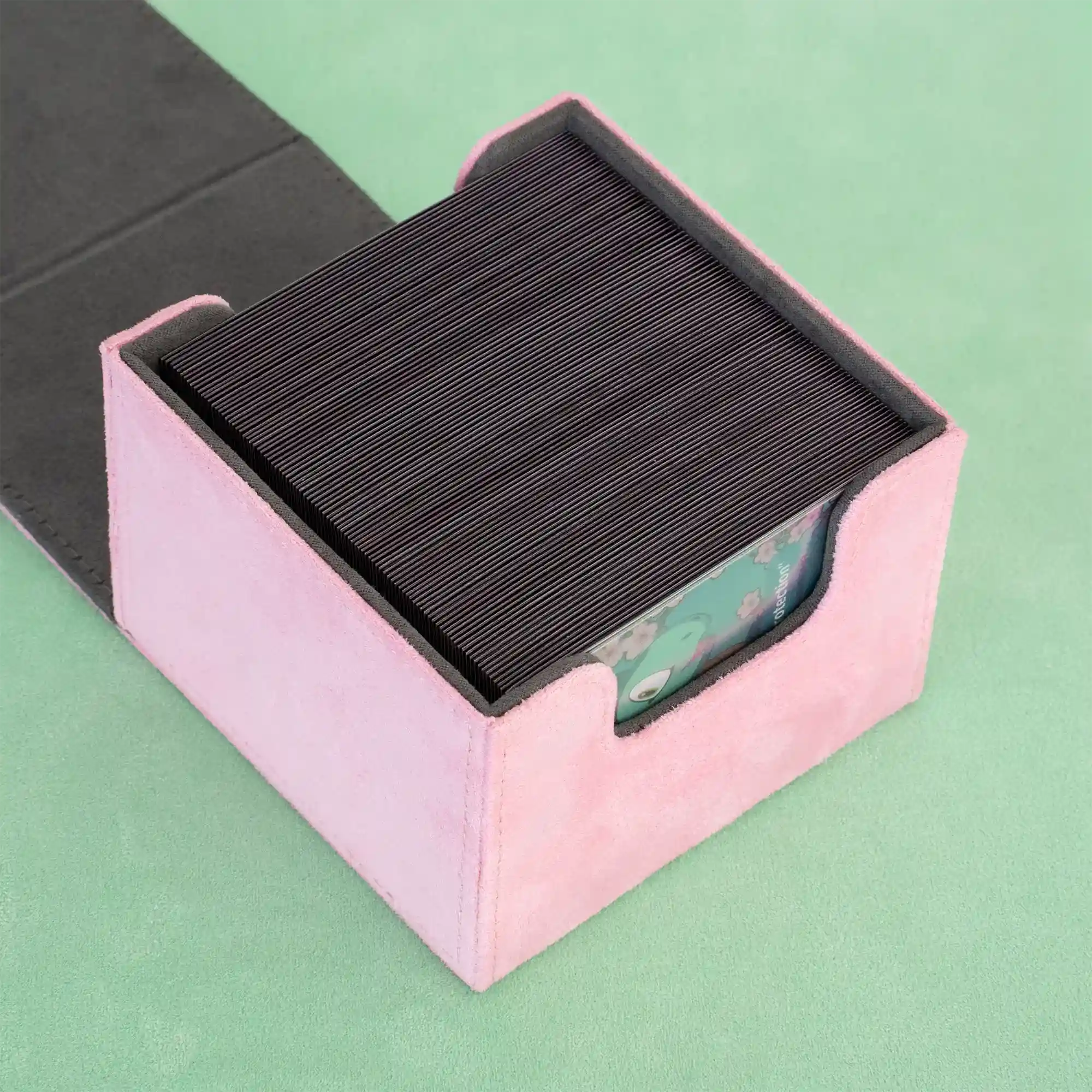 detail view of opened pastel pink resiplush cardcove deck box filled with up to 133 double-sleeved tcg cards